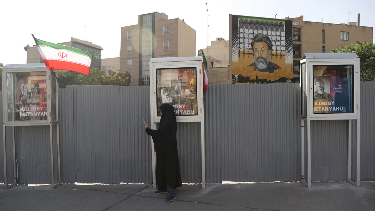 A woman stands on a street, amid the Iran-Israel conflict, in Tehran, Iran