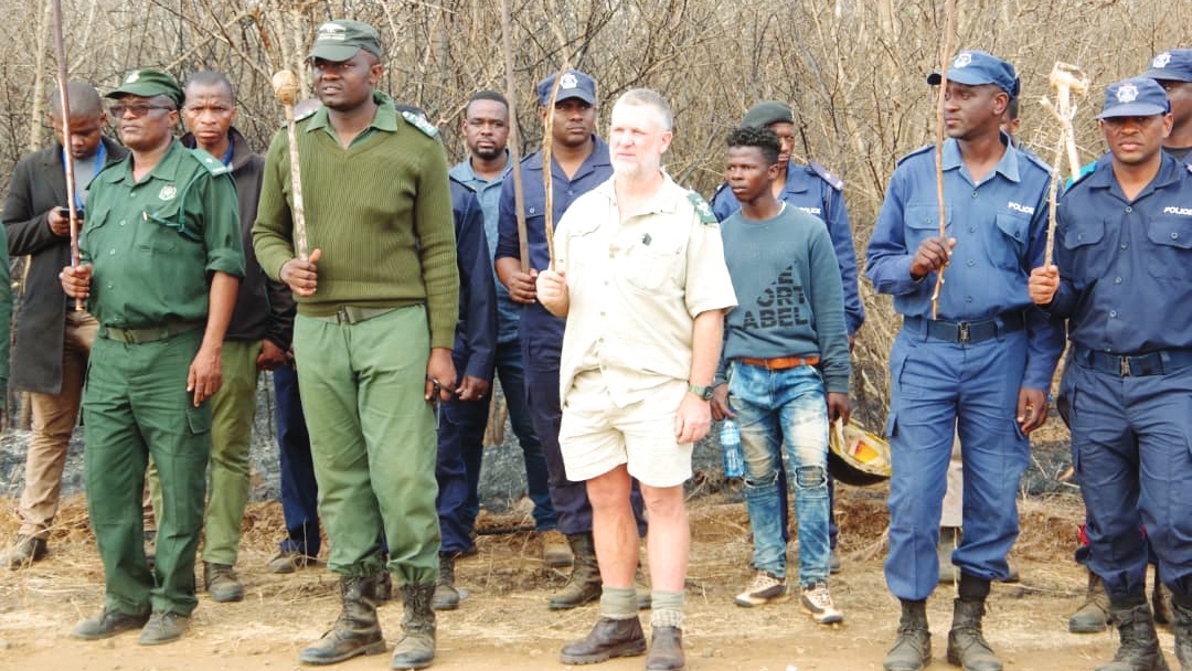 Jubela (in shorts) dancing with members of the security forces ahead of Butimba.
