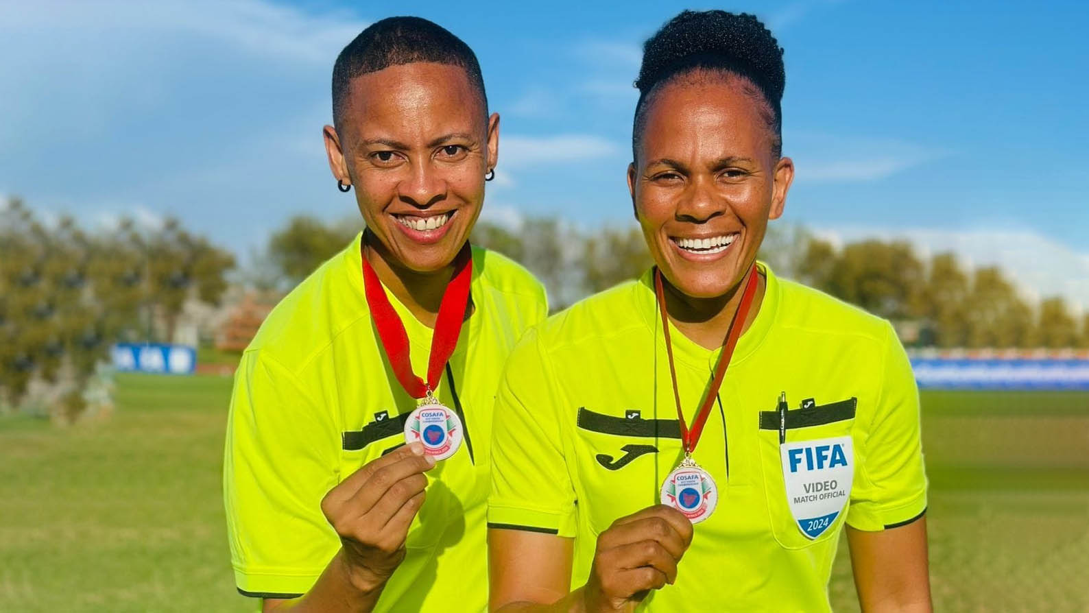 Letticia Viana (L) bragging with one of her medals she got from officiating in the COSAFA Cup.