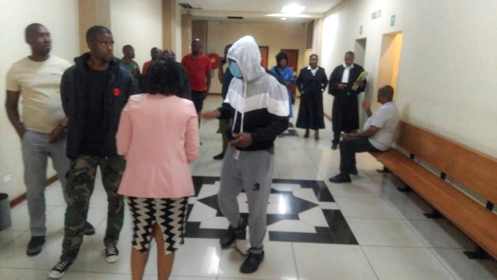 Businessman Zweli Dlamini in leg irons being escorted after his remand last Wednesday.