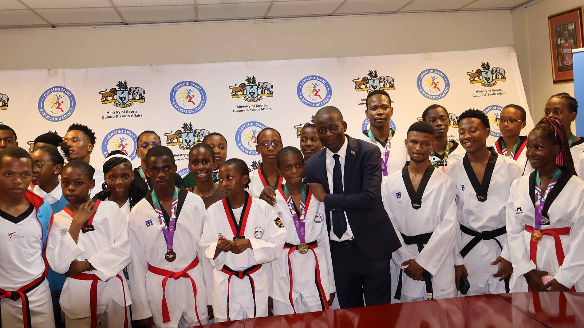 Minister for Sports, Culture and Youth Affairs Bongani Nzima poses for a photo with the taekwondo team, which received over E200 000 in podium performance incentives.(Pics: Sanele Jele)