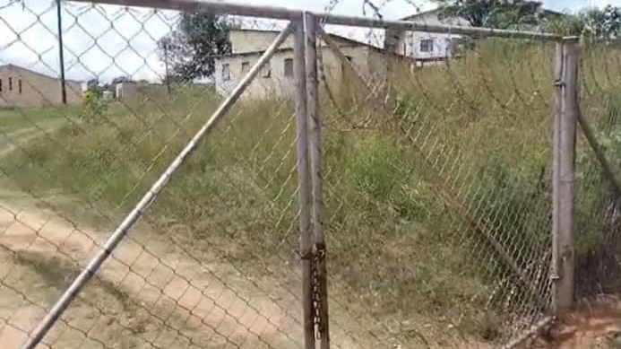 The locked gate leading to the church.
