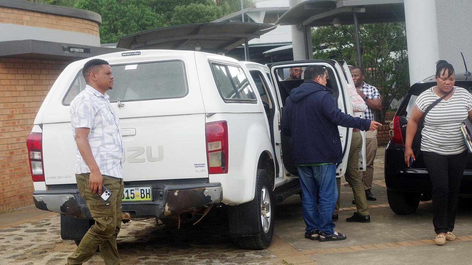 Jin Houyun in conversation with his countrymen before boarding the police van. (Pics: Sibusiso Shange)
