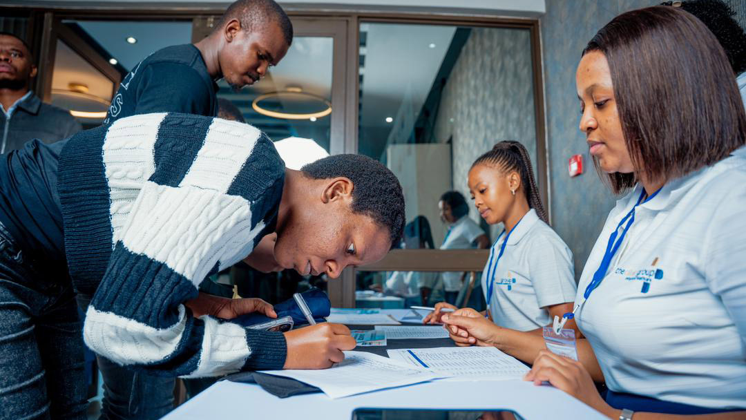 Attendees of the symposium register on arrival.