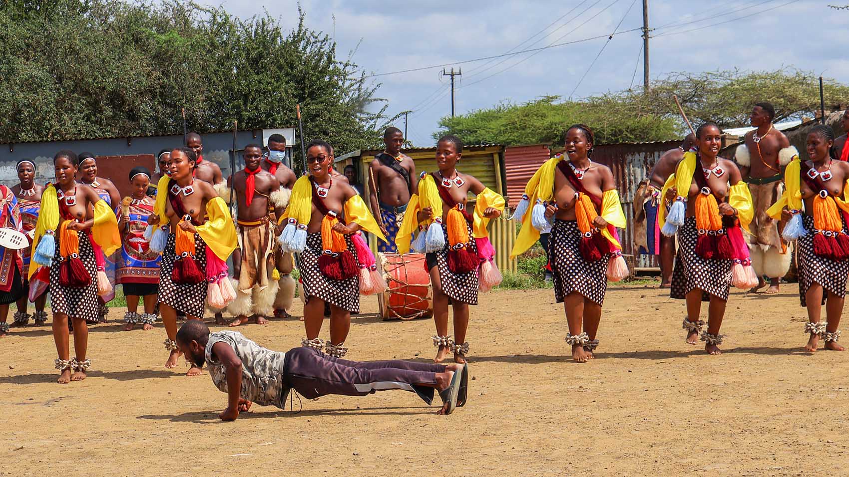 Mehlwengwadla performs some push-ups to show off his strength as the maidens dance