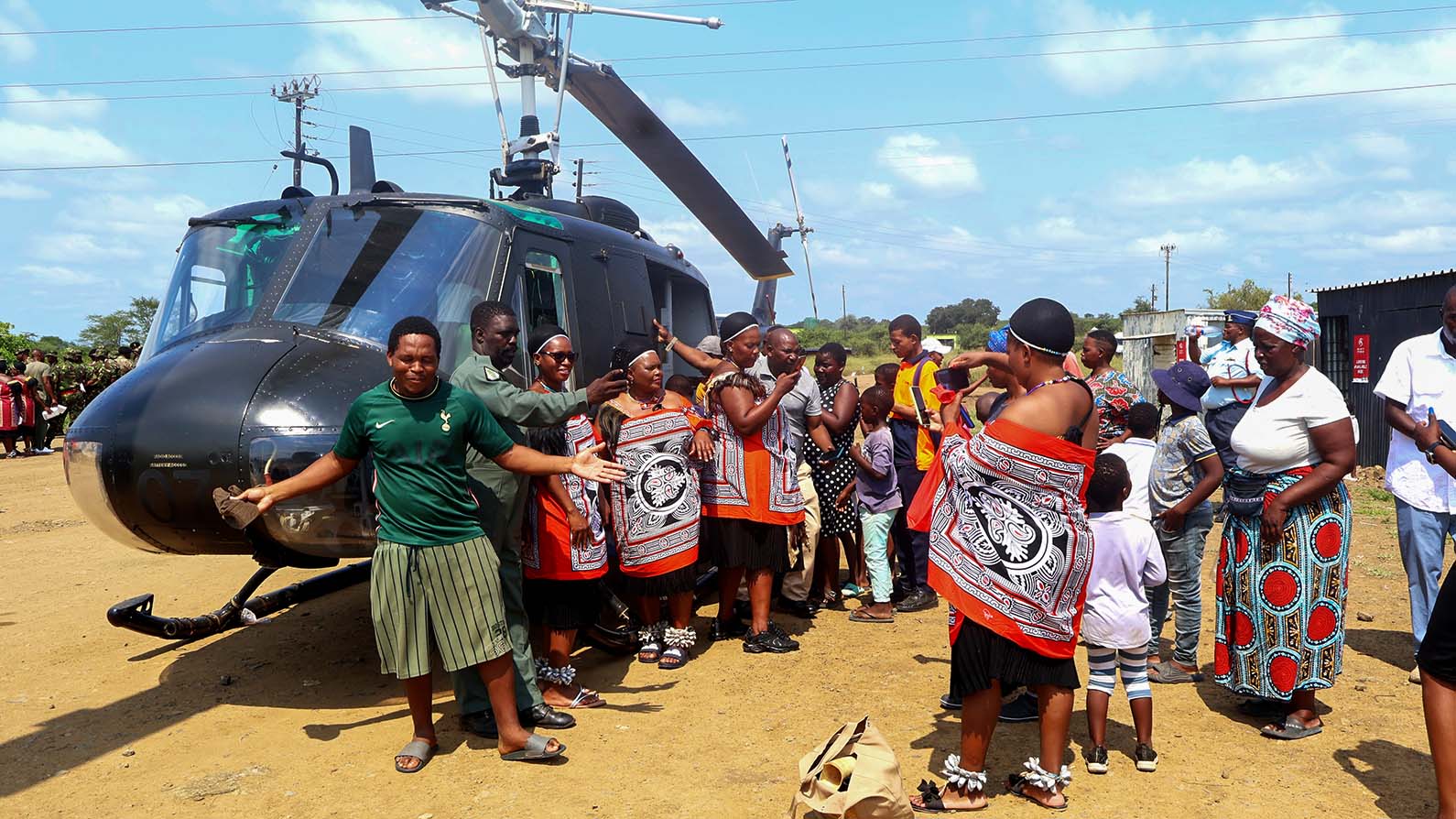 Members of the public pose outside an army helicopter during the mini army day held at Mpaka while pilot Sibonginkosi Tsela who is a pilot under the army's airwing.