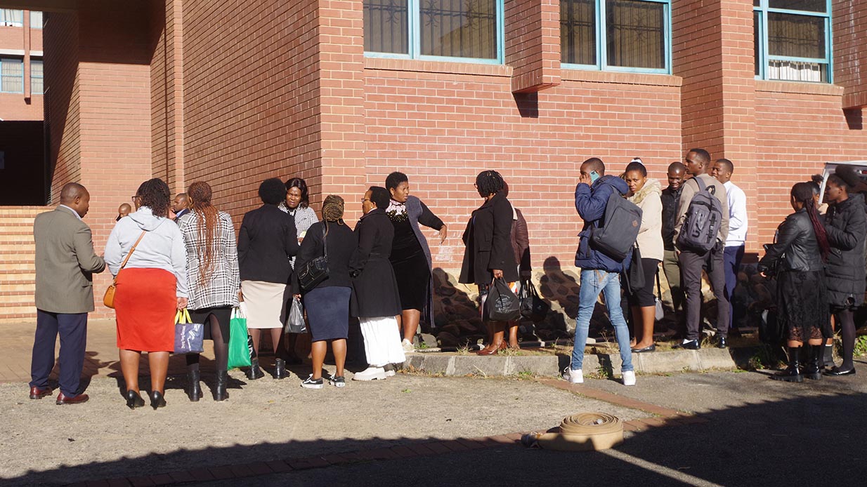 Some of the employees awaiting instructions upon learning about the incident.
