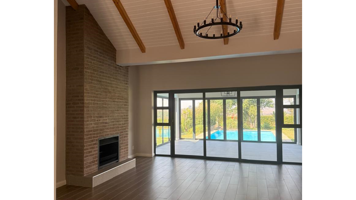 The expansive lounge area is good for relaxation with its cosy fireplace, while the adjoining sunroom with glass doors allows for breath-taking views of the swimming pool. (