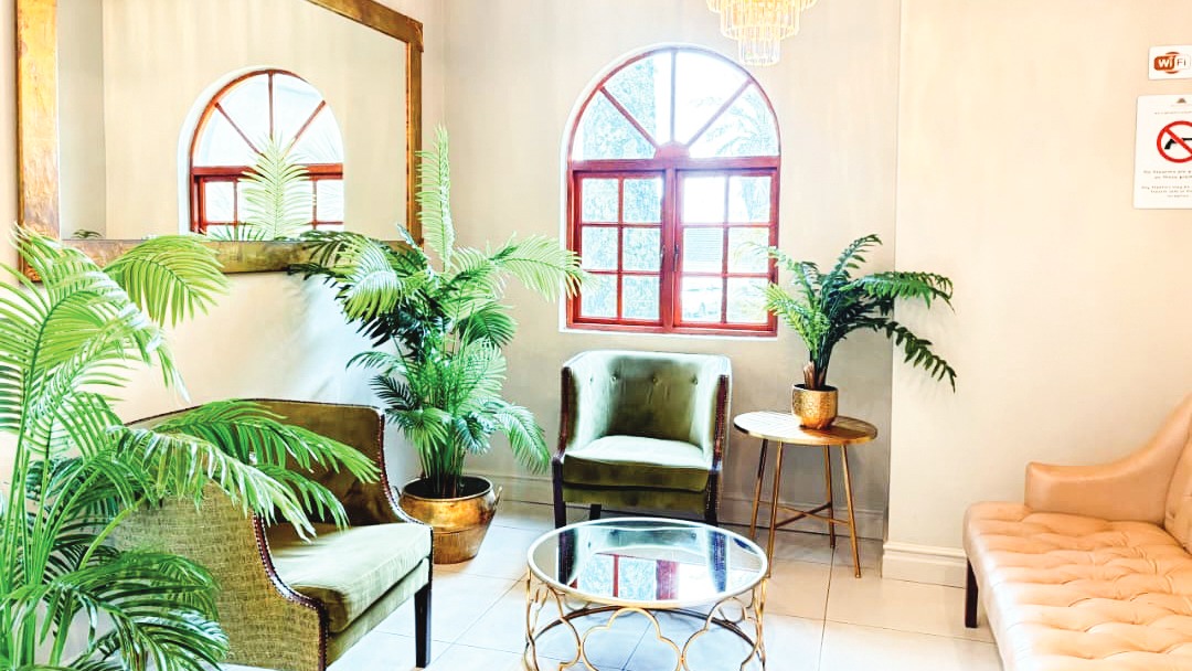 Waiting area by reception: Each room is designed and decorated differently to be personal and unique, from the cool green of the breakfast room to the subtle solemnity of the library.