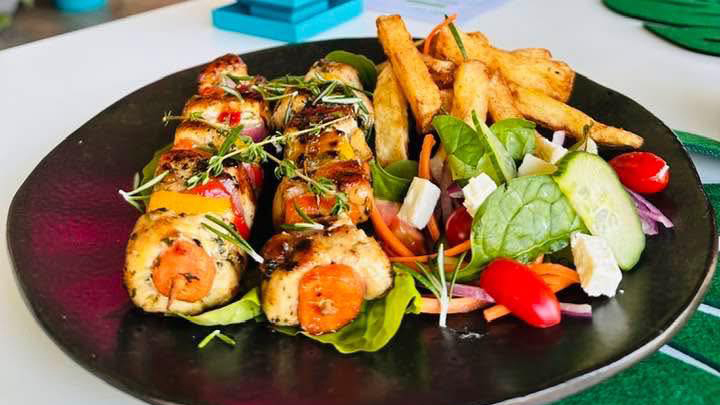 Lunch goals unlocked! Treat yourself to some flavour-packed skewers and crispy fries amid the vibrant greenery. You deserve this!