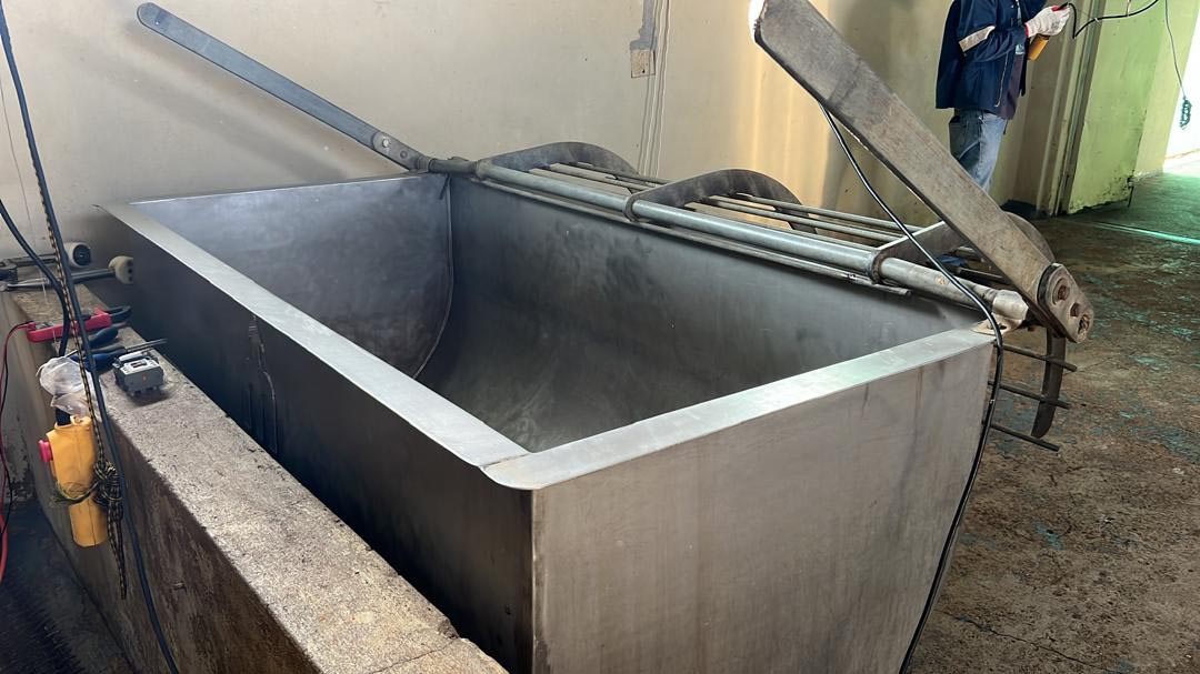 An automatic stainless steel hog feeder trough.