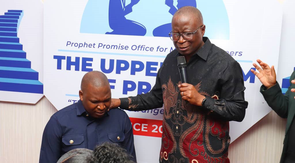 Apostle Dr C Samunenge laying hands on  Prophet Promise.