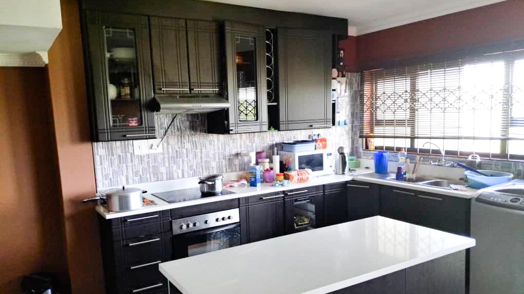 A view of the fitted kitchen with an electric stove.