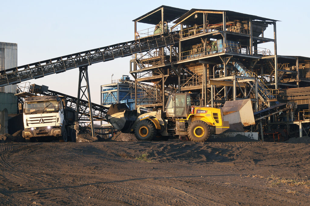 Loader transfers coal waste onto a haulage truck as production resumes, signalling a return to normal operations at Maloma Colliery Limited.