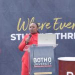 Sharon Maziya addressing students at the podium, equipping them with essential skills on building effective LinkedIn profiles and CV writing during the event.