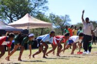 Athletes explode from the starting line during one of the sprint events at the 2026 ISASA Eswatini Primary Schools Interschools Athletics Championships.