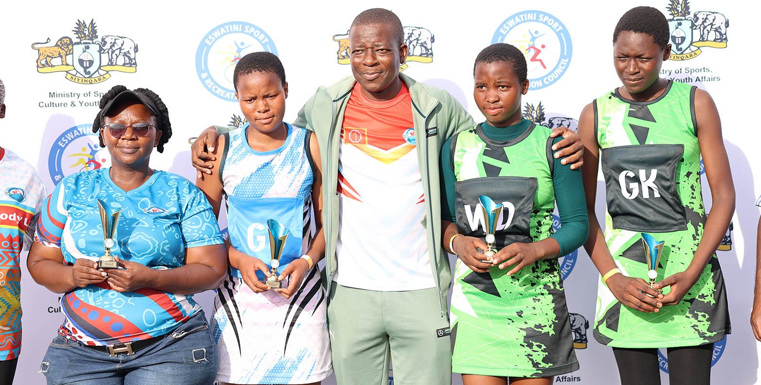 Minister for Sports, Culture and Youth Affairs Bongani Nzima flanked by standout individual performers of 2026 Tinkhundla Talent Search Netball Competition, a grassroots initiative he credited with also helping drive the ministry to top-performing status. (Pic: Nimrod Hlophe)