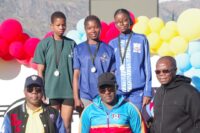 Girls’ 100m medallists (back row L-R) Eswatini’s Thandiwe Metiso, Yoliswa Simelane and Seychelles’ Aaliyah Nicette receive their medals from National Games LOC Chairman Zakhele Dlamini (R), Sports Council’s Dan Mavuso (C) and Eswatini National Olympic Committee Treasurer Zakhele Zulu. (Pic:Nimrod Hlophe)