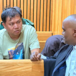 Li Peng Chi and Lawyer Sifiso Jele in discussion during his previous appearance at the High Court of Eswatini.