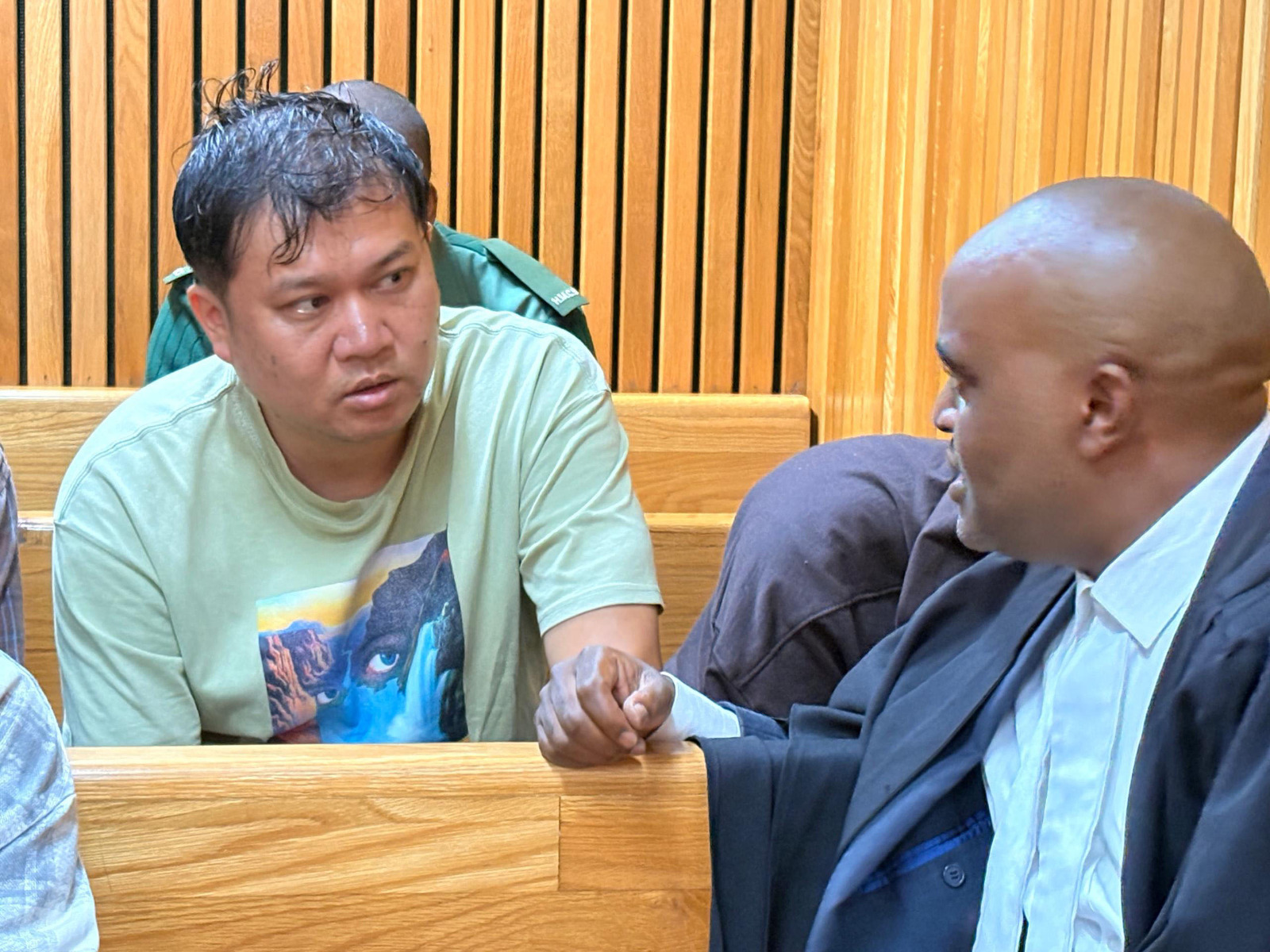 Li Peng Chi and Lawyer Sifiso Jele in discussion during his previous appearance at the High Court of Eswatini.