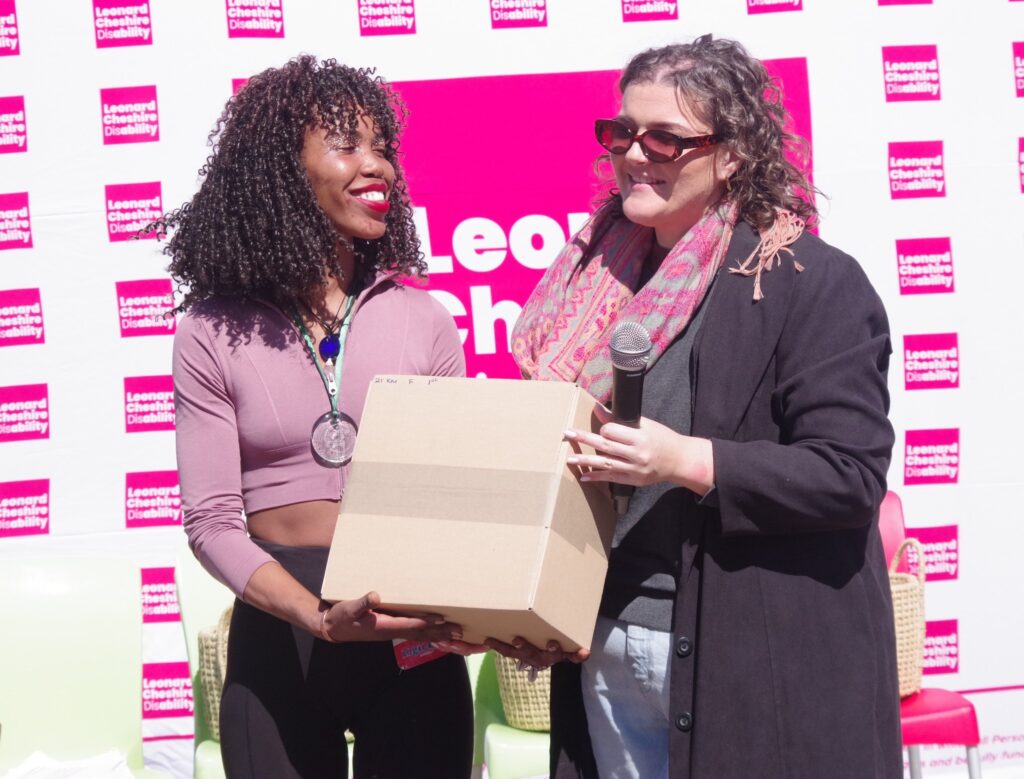 Ngwenya Glass Marketing's Lara Prettejohn (R) presents the Ngwenya Mountain 21km Trail Run female winner, Nosi Dlamini.(Pic:Nimrod Hlophe)