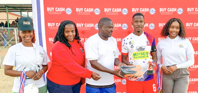 Pigg’s Peak Clean Up Campaign organising team members Busisiwe Simelane, Nomcebo Matsebula and Busta Vilakati hand over soccer boots to Player of the Series Innocent Mphahleni of KaMhlushwa Real Madrid, alongside Highlands Inn’s Olivia Hlophe, during the prize presentation.