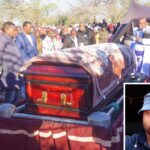 The late Themba Ncongwane's casket being lowered down into the grave at his homestead at Duze.