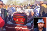 The late Themba Ncongwane's casket being lowered down into the grave at his homestead at Duze.
