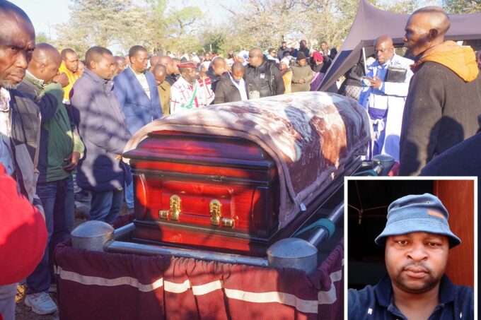 The late Themba Ncongwane's casket being lowered down into the grave at his homestead at Duze.