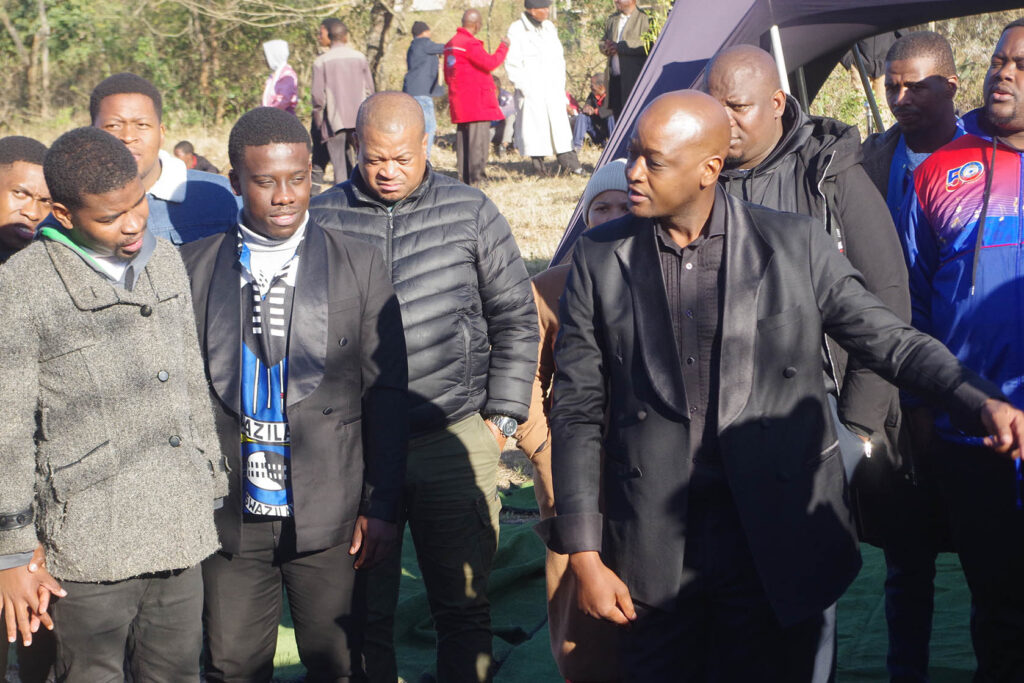 Tiro Mpane conducting the choir while gathered around the late Themba Ncongwane's grave grave.