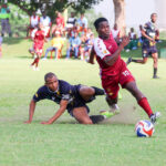 Manzini Wanderers' Mayibongwe ‘Mgadzanga’ Sacolo (R) gallops with the ball, leaving Ubombo Sugar defender Samkelo Ginindza behind. (File pic)