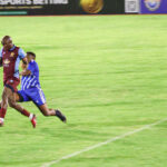 Young Buffaloes’ Bongwa Matsebula races away with the ball as Pigg’s Peak Professionals’ Mlandvo Gumedze gives chase during the 8Bet Trade Fair Cup last-16 clash. (Pic: Sanele Jele)