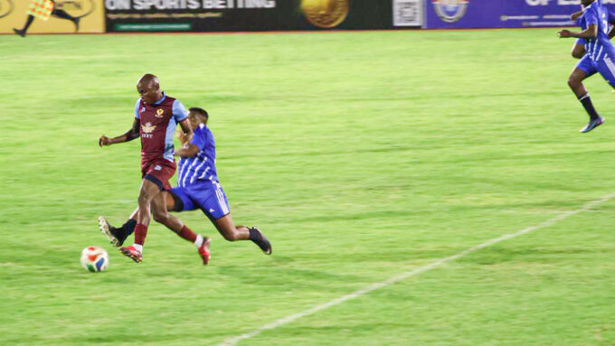 Young Buffaloes’ Bongwa Matsebula races away with the ball as Pigg’s Peak Professionals’ Mlandvo Gumedze gives chase during the 8Bet Trade Fair Cup last-16 clash. (Pic: Sanele Jele)