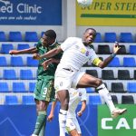 Eswatini Captain Njabulo Gama in a heading duel with South Africa's Sanele Simelane. (Pic: COSAFA)
