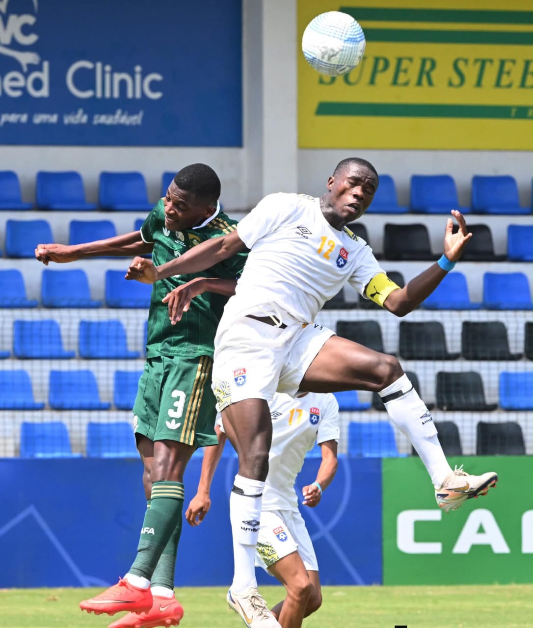 Eswatini Captain Njabulo Gama in a heading duel with South Africa's Sanele Simelane. (Pic: COSAFA)