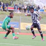 Mbabane Highlanders' Sphiwe Cele negotiates his way past Green Mamba's Mphumuzo Sangweni during the MTN Premier League opener. (Pic: Nimrod Hlophe)