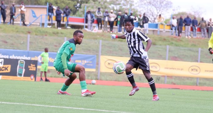 Mbabane Highlanders' Sphiwe Cele negotiates his way past Green Mamba's Mphumuzo Sangweni during the MTN Premier League opener. (Pic: Nimrod Hlophe)