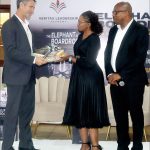 Sibusiso Nhleko and his wife present a gift to the Minister for Finance Neal Rijkenberg after his speech.