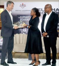 Sibusiso Nhleko and his wife present a gift to the Minister for Finance Neal Rijkenberg after his speech.