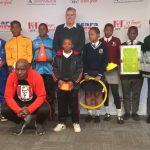 The legendary Absalom 'Scara' Thindwa squatting, the pupils and KFC CEO Nigel England after the presentation. (Pic: Times of Eswatini)