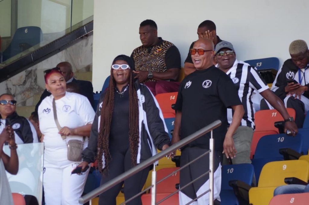 Highlanders AM boss Shauwn 'MaMkhize' Mkhize (C), General Manager (GM) Richard Makhoba (R) dance in celebration as the club cruised over Amawele.
