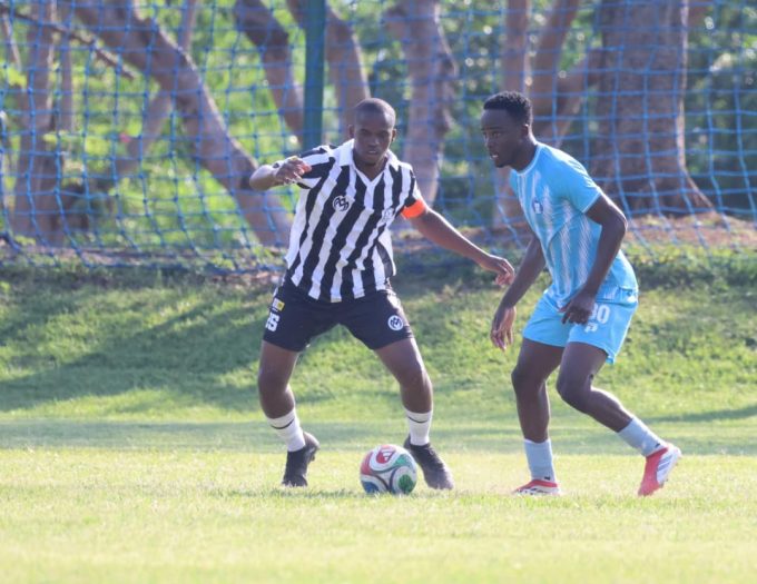 Mbabane Highlanders AM skipper Sandziso Dlamini tries to protect his ball as Banele 'Neymar' Shongwe of Royal Leopard closes in. Leopard won the match 2-0.