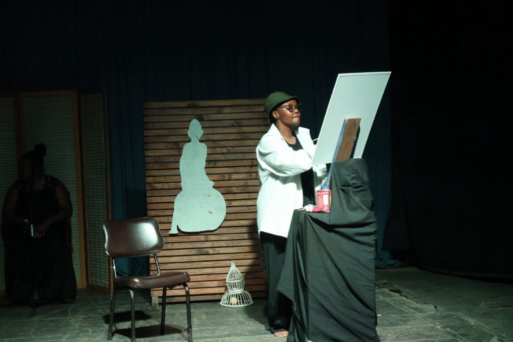 Sibonisiwe the painter in the play painting her character ‘Sihle’ , a black, fearless woman.