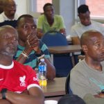 Moneni Pirates South African tactician Selaotse 'Sly' Mosala (R) follow proceedings of the coaches AGM at Sigwaca House in Mbabane on Sunday. (Pic: Nimrod Hlophe)