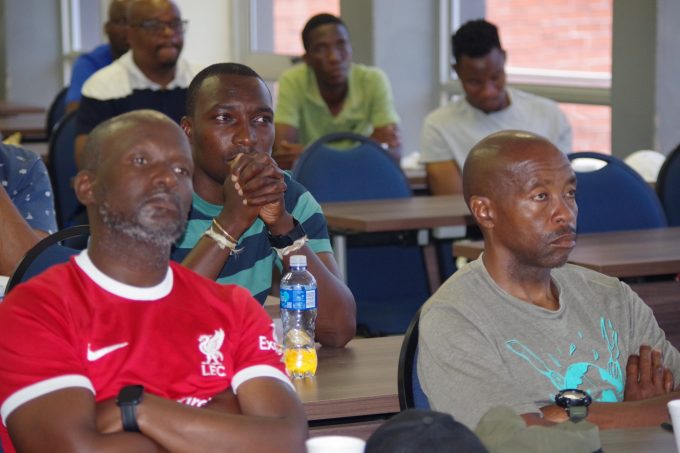 Moneni Pirates South African tactician Selaotse 'Sly' Mosala (R) follow proceedings of the coaches AGM at Sigwaca House in Mbabane on Sunday. (Pic: Nimrod Hlophe)