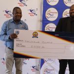Melisizwe Zwane(R) receiving his E5 000 from Eswatini Med Principal Officer Sicalo Mkhonta